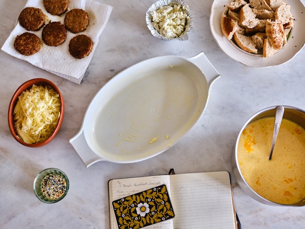 Ingredients to make an Everything Bagel Breakfast Casserole arranged on a marble counter