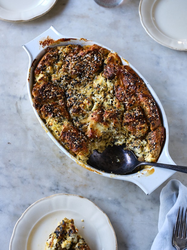 Top down view of Breakfast Casserole on marble table with spoon in baking dish