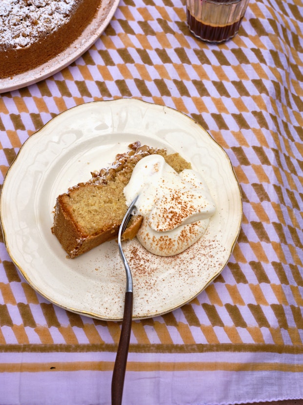 Slice of Cake with Whipped Cream on Purple Tablecloth