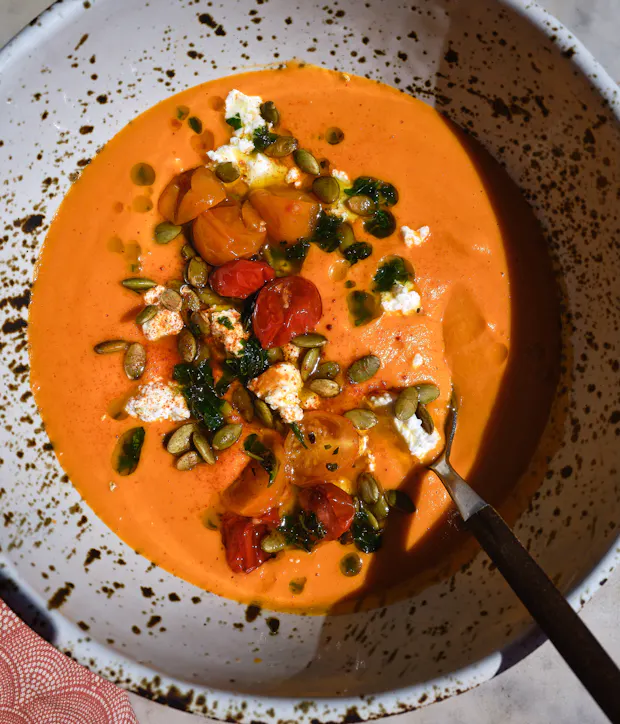 butternut squash soup with red lentils and toppings in a bowl