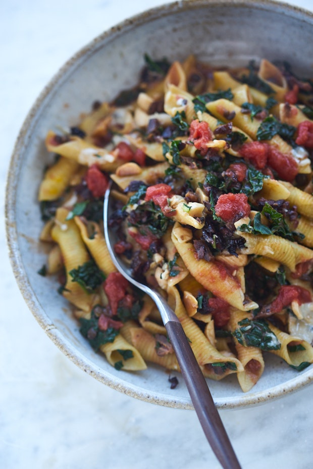 garganelli pasta in a bowl with kale and lentils and other ingredients