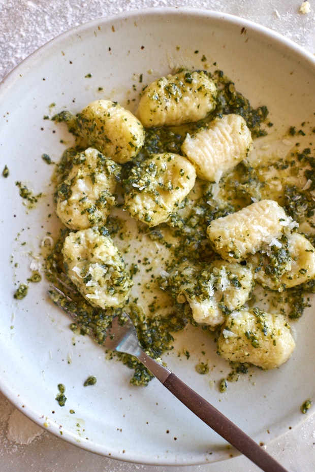 Gnocchi served on a plate with pesto