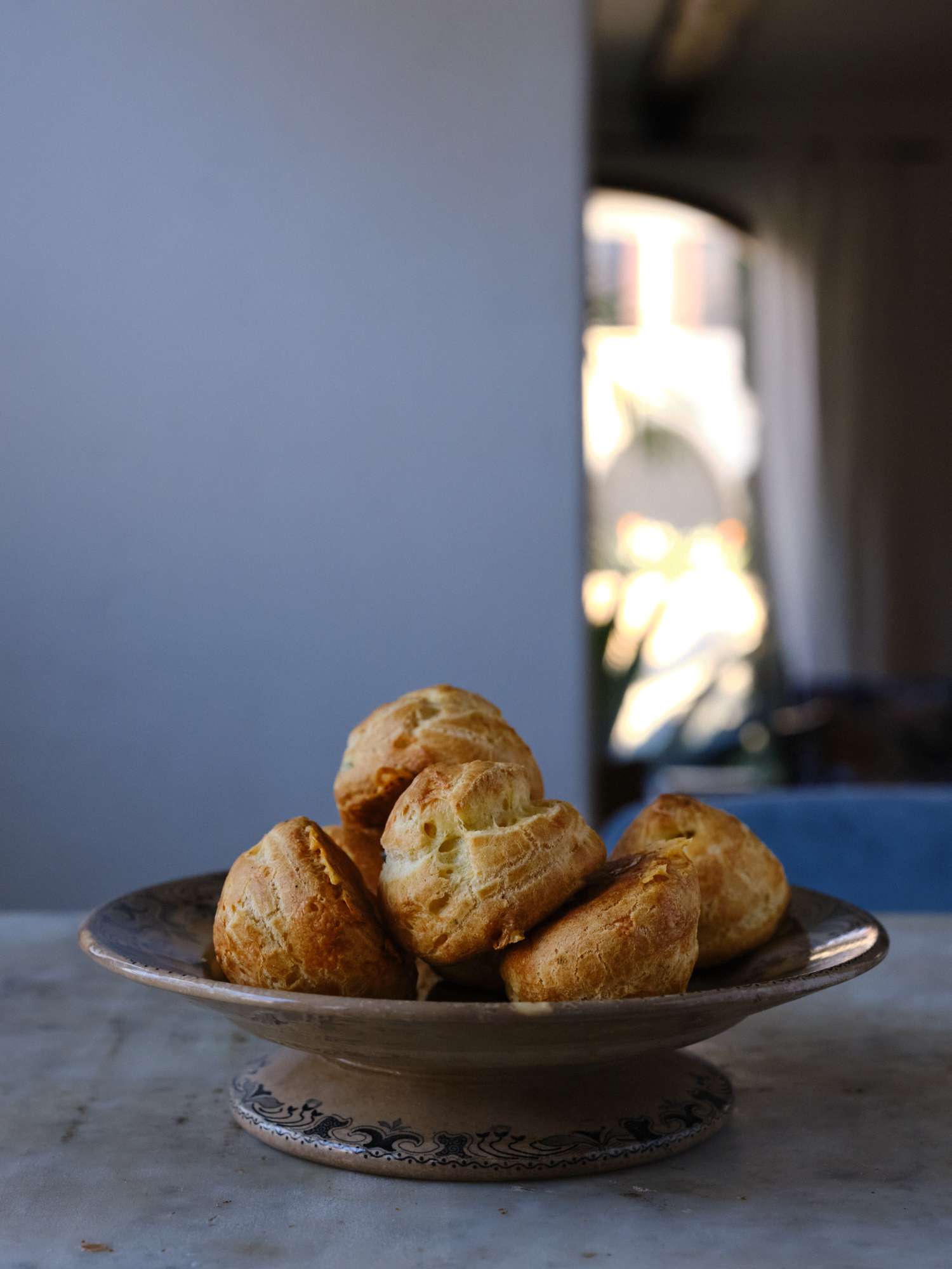 Gougeres piled high on a marble table