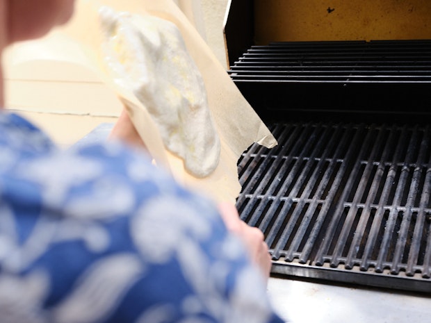 Placing dough on hot grill