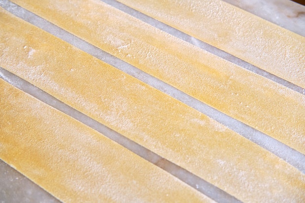 pasta sheets on a floured countertop