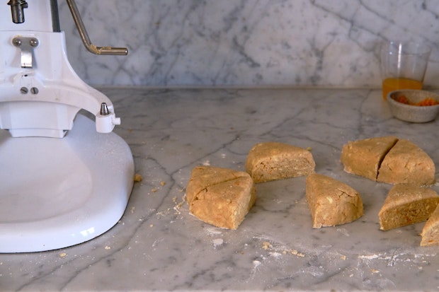 Scone dough cut into wedges on a countertop