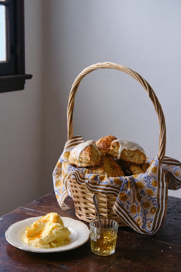 Scones for Brunch in a Basket alongside a Plate of Butter and Honey