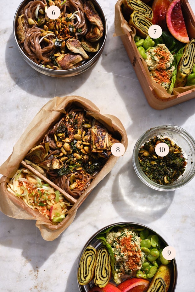 A selection of lunch ideas arranged on a table including soba noodles, tamagoyaki, slaw and spiced seeds