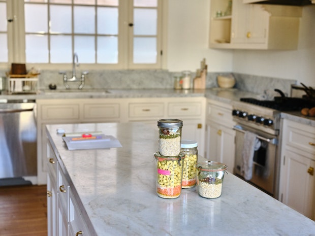 A Collection of Meals in Jars on Marble Counter