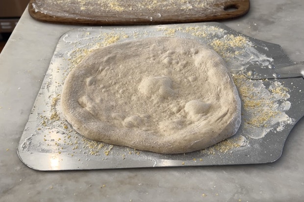 Photo of Pizza Dough on Flour and Cornmeal Dusted Pizza Peel Ready for Toppings