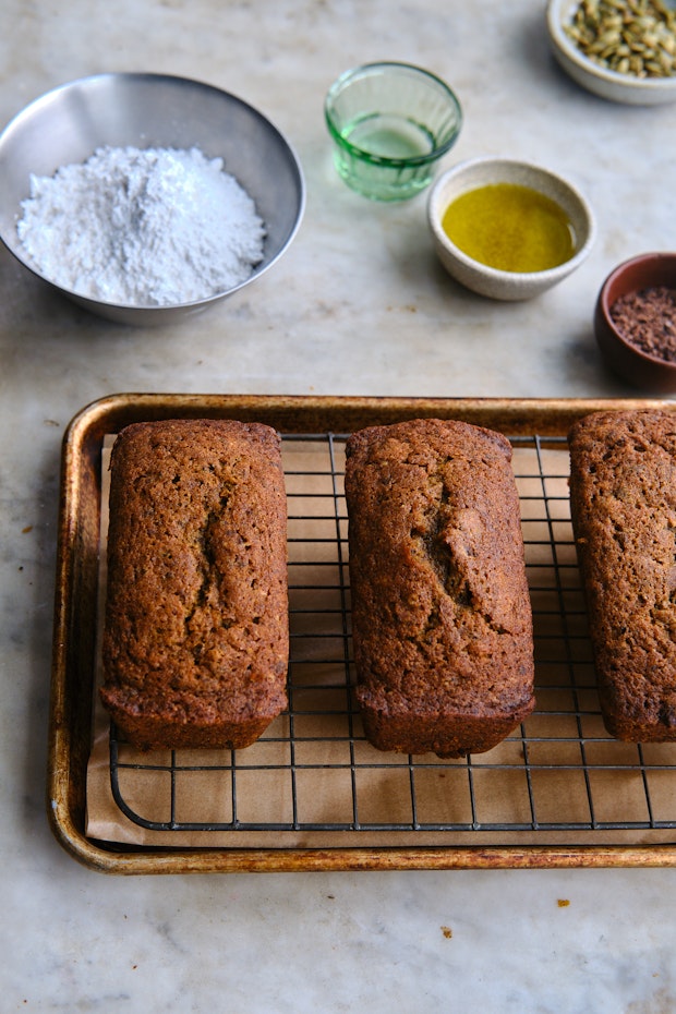 Ingredients for icing pumpkin breads arranged on a counter