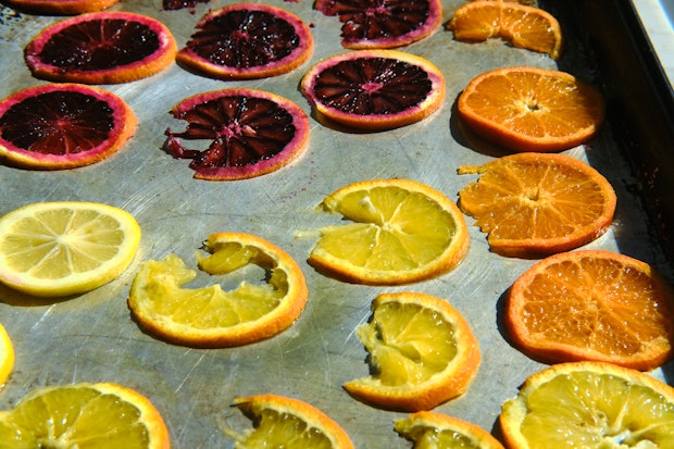Sliced citrus on a baking sheet to make roasted citrus before baking