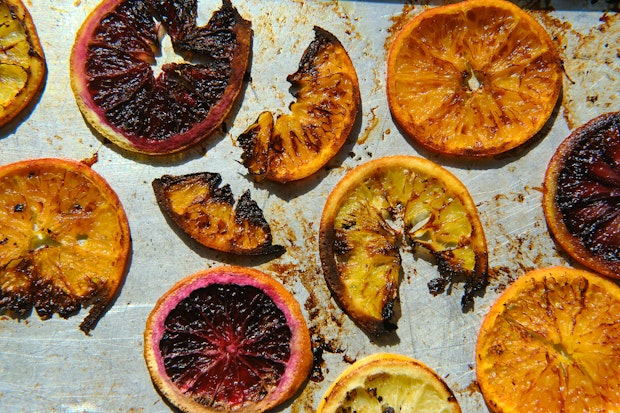 Sliced citrus on a baking sheet to make roasted citrus after baking