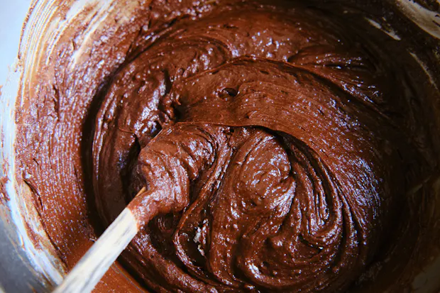 Brownie batter being mixed with a spatula