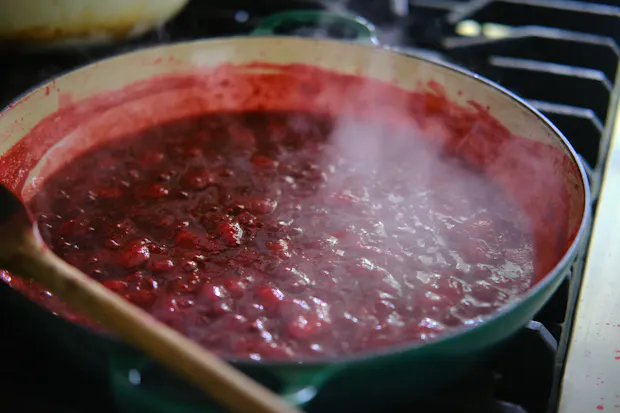 Fruit for jam simmering in a wide pot