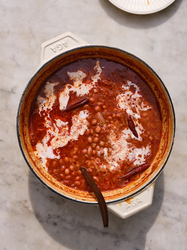 A White Pot of Coconut Beans on a Marble Counter waiting to be Served