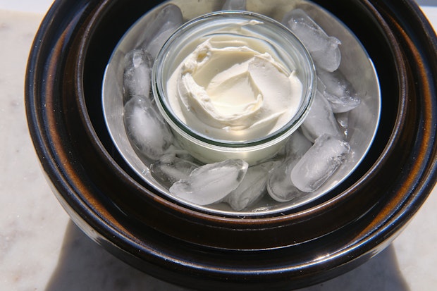 Labneh in a donabe smoker in an ice bath
