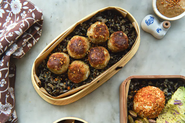 Pan-fried tempeh ponzu balls in a bento box with other lunch items