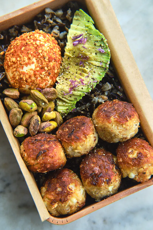 Pan-fried tempeh ponzu balls in a bento box with other lunch items