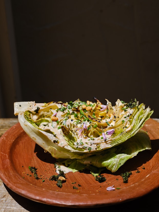 Grilled wedge salad with spicy buttermilk ranch dressing on a plate