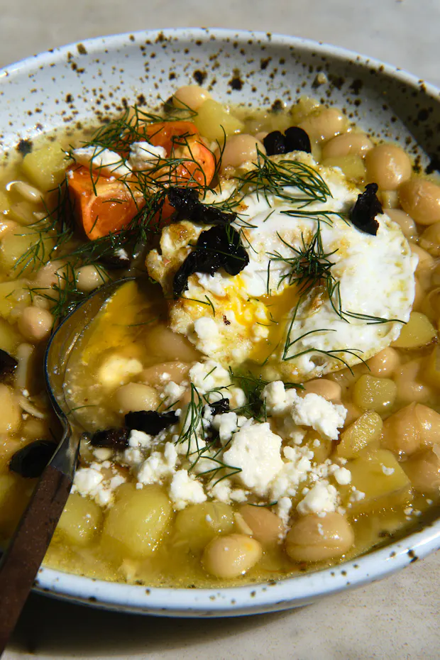 white bean soup in a wide bowl with various toppings