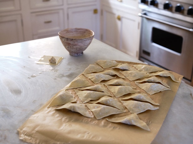 Prepare the wontons and place them on a parchment-lined surface