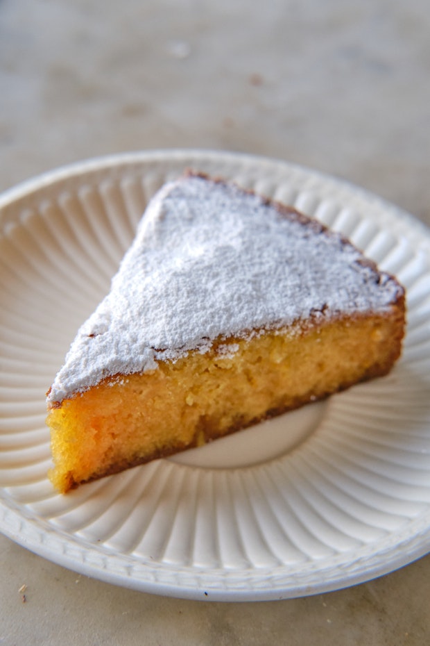 slice of almond cake on a plate with a fork