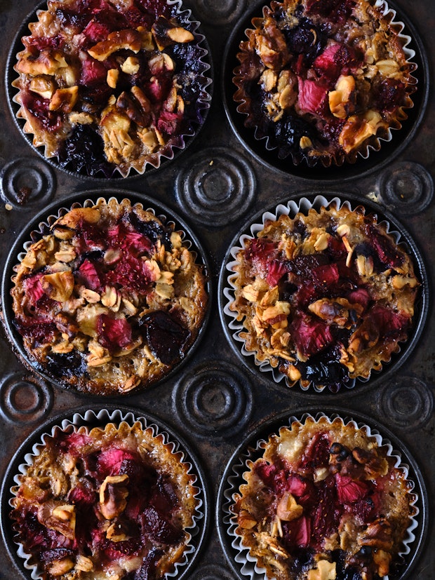baked oatmeal cups with lots of berries in a muffin tin