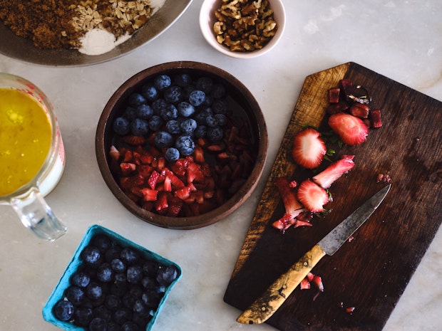 ingredient photo including strawberries, blueberries, walnuts, oats, and brown sugar