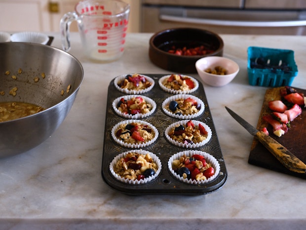 Spread the oatmeal cup batter in a muffin tin on a countertop before baking