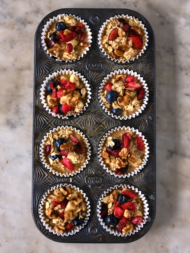 close up photo of oatmeal cup batter in muffin tin on a counter before baking