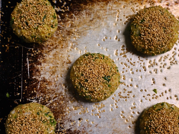 Quinoa patties on a baking sheet prior to baking