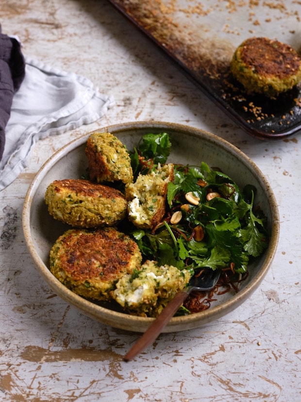 Quinoa patties in a bowl served with a side salad