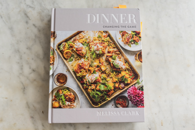 Melissa Clark's book Dinner: Changing The Game on a marble counter