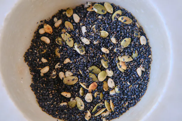 black sesame seeds with nuts in mortar