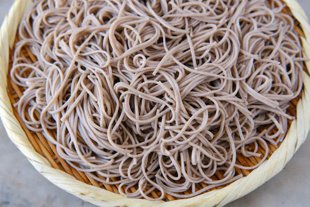 soba noodles draining on a mat