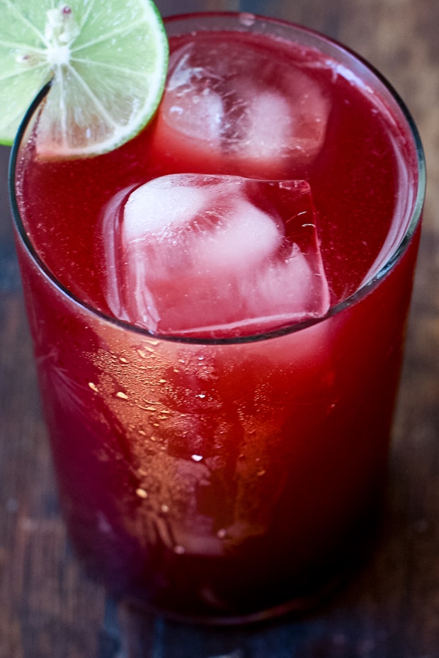 blackberry limeade in a glass with ice cubes