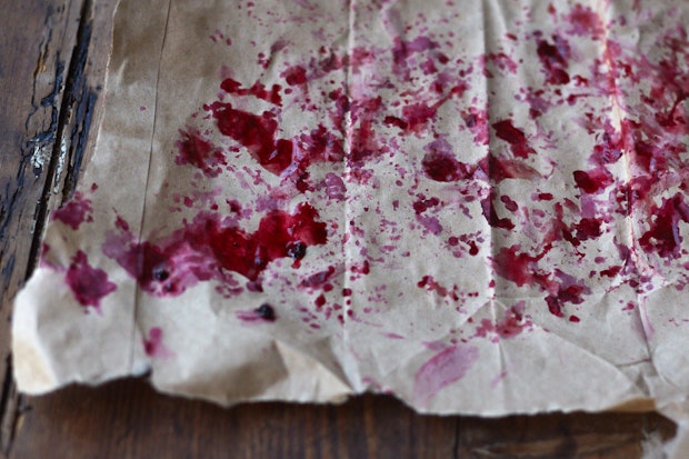blackberry juice stains on a piece of parchment paper