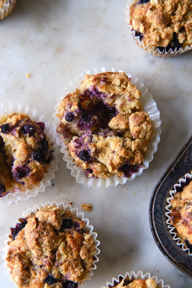 blueberry muffins cooling on a marble counter