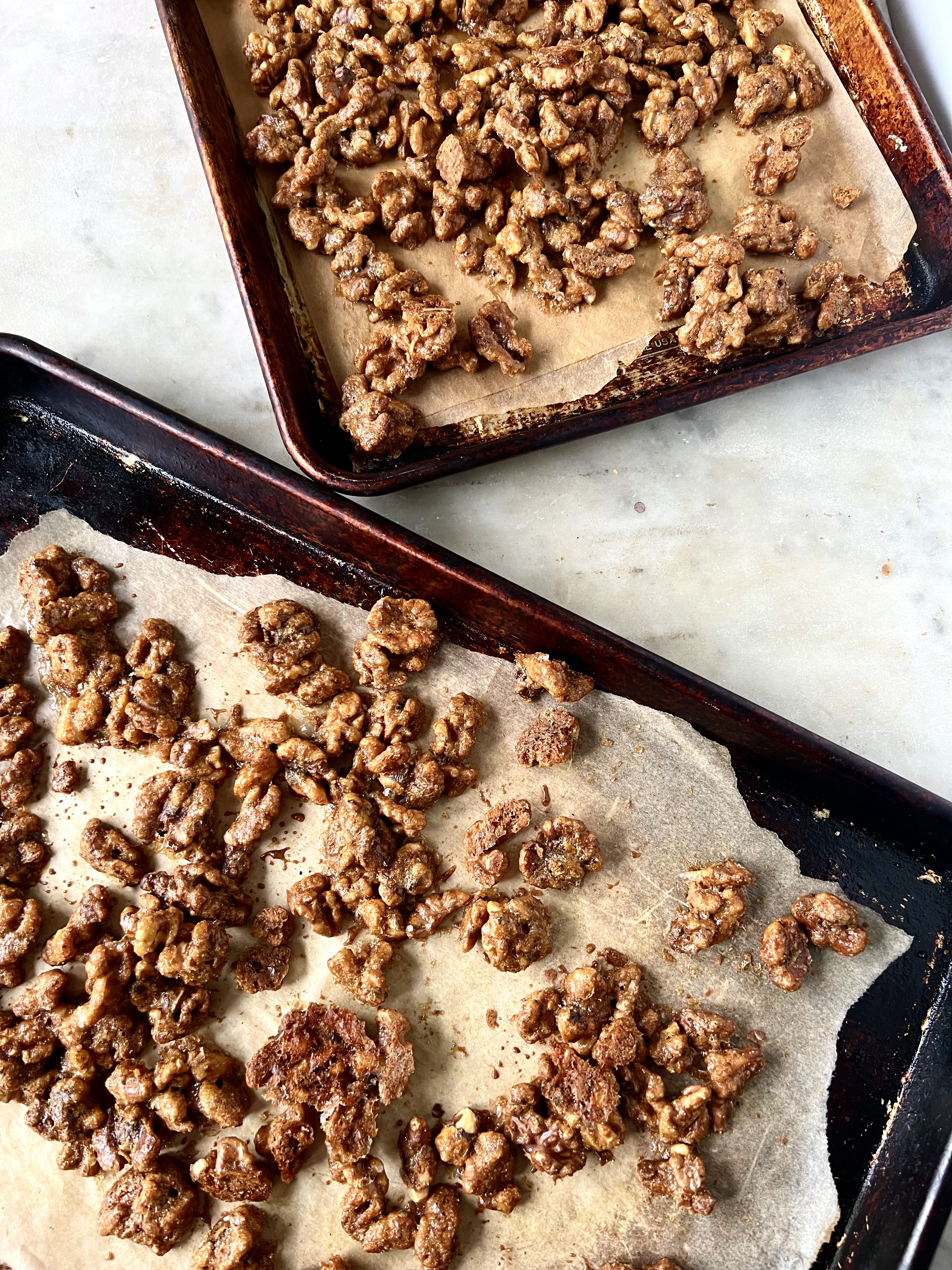 Two pans of candied walnuts to cool