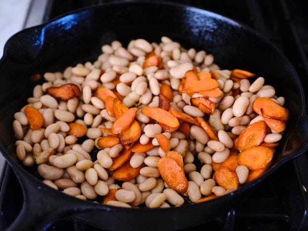 Carrots and beans in a cast iron skillet