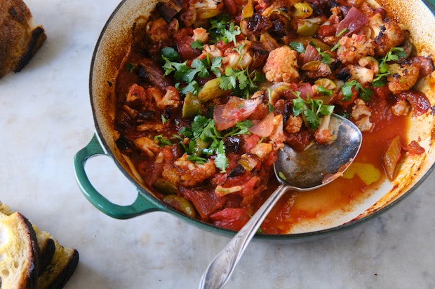 kembang kol caponata dalam piring saji bersama roti