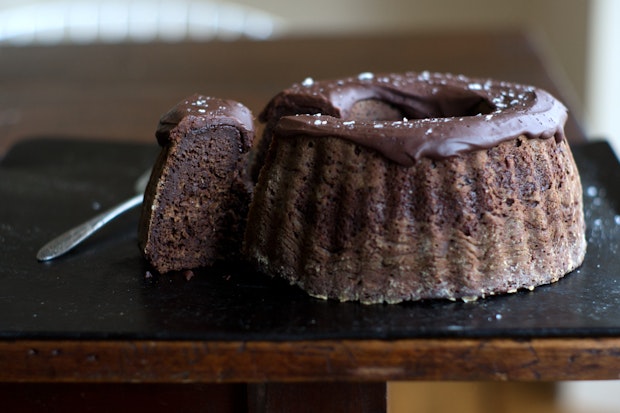 a chocolate bundt cake sitting on top of a table ready to be served