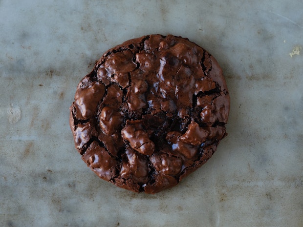 close up of chocolate cookie on a marble countertop