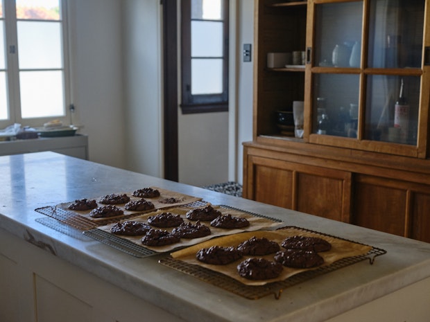 chocolate cookie cooling on racks in a kitchen