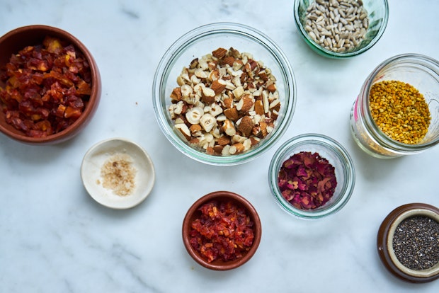 a range of topping ingredients including rose petals, dried plums, almonds, chia seeds