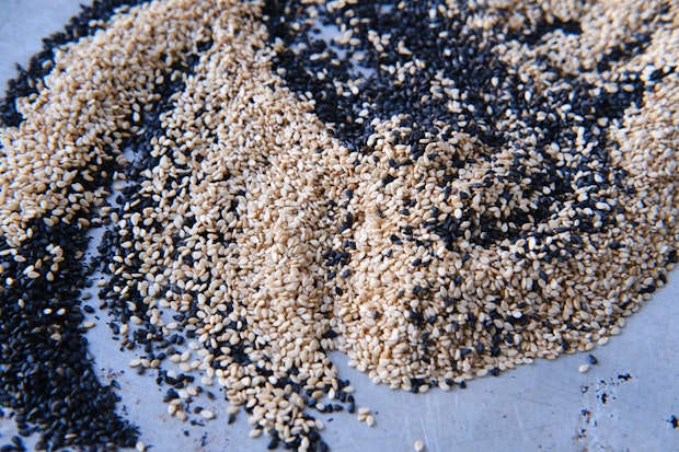 sesame seeds on a baking sheet to be toasted