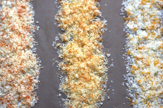 three different examples of citrus salt drying on baking sheet