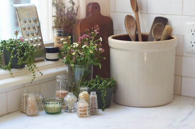 a range of homemade citrus salts in glass jars in a kitchen corner