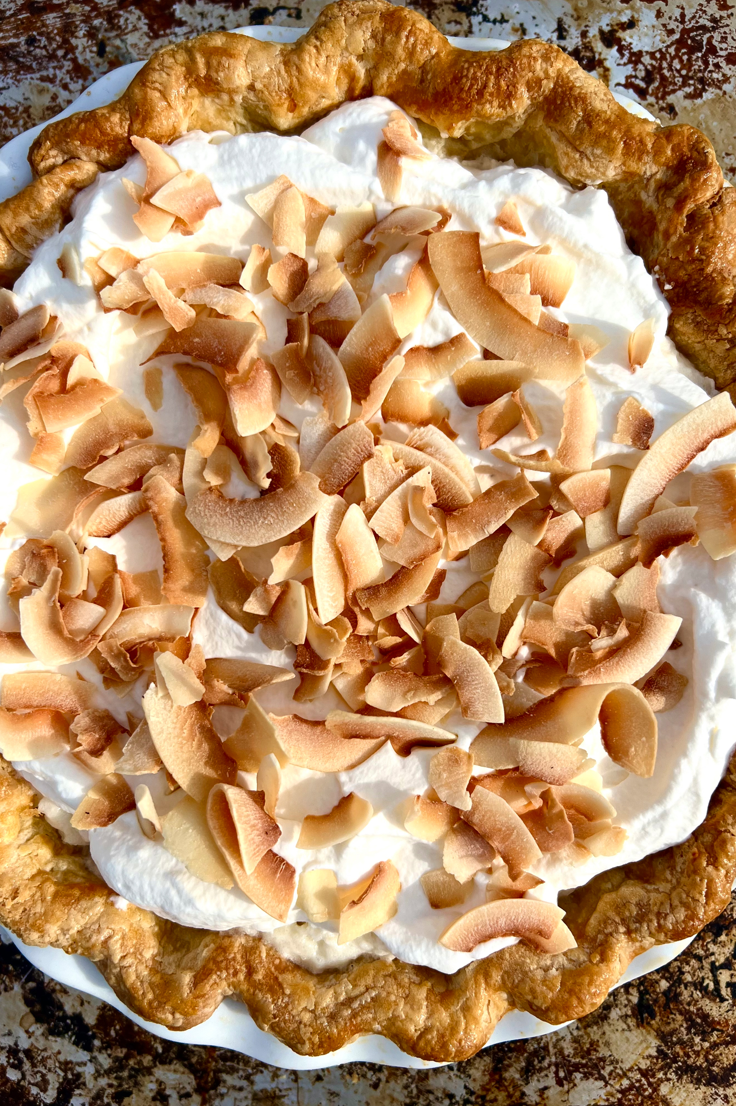 A whole coconut cream pie photographed from above